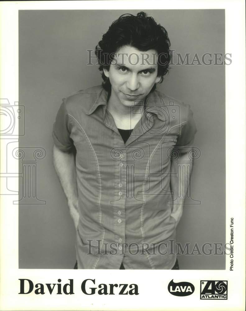 Press Photo Musician David Garza stands and smiles in portrait - Historic Images