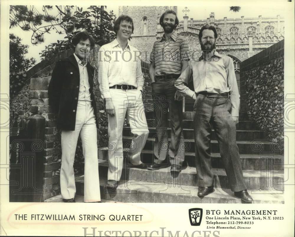 Press Photo Four Members of The Fitzwilliam String Quartet smile standing - Historic Images