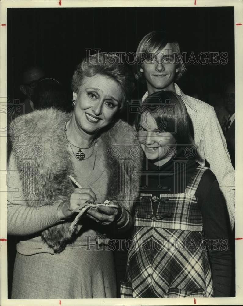 1977 Press Photo Actress Celeste Holm signs autograph for Doug, Mary Alice Price- Historic Images