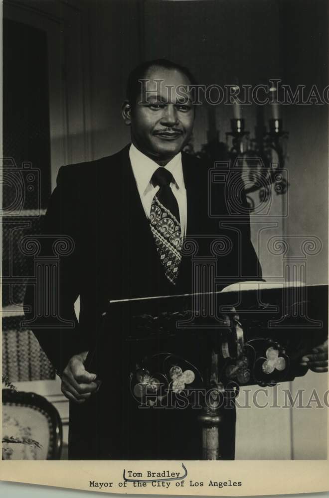 Tom Bradley, Mayor of the City of Los Angeles, standing at podium - Historic Images