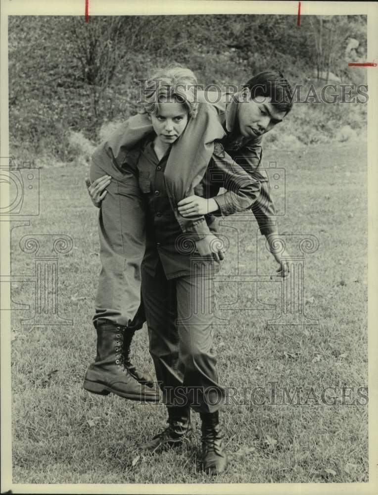 Actress Linda Purl carries Actor in scene - Historic Images