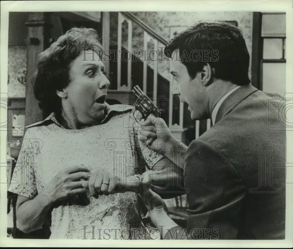 Press Photo Man Points Gun at Scared Woman in Acting Scene - Historic Images