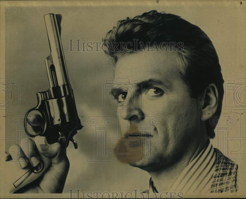 Actor David Rasche Holds Gun - Historic Images