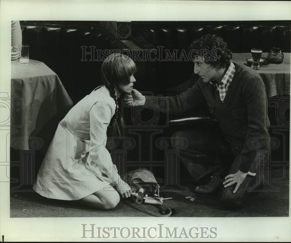 Press Photo Woman in Bar Picks up Dropped Purse, Man Helps - Historic Images