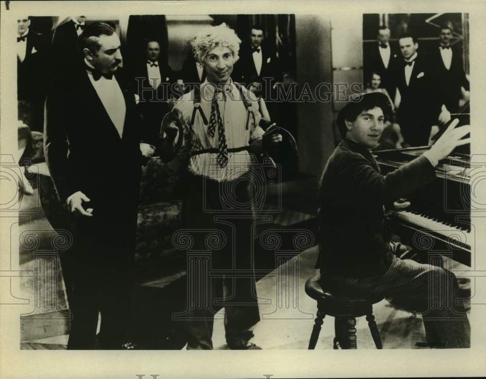 Press Photo Men in Tuxedos Watch as Entertainers Perform With Cymbals & Piano - Historic Images