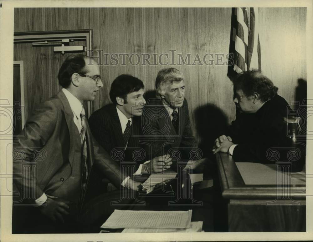 Press Photo Three Men Lean in To Talk To Judge in Courthouse Scene - Historic Images