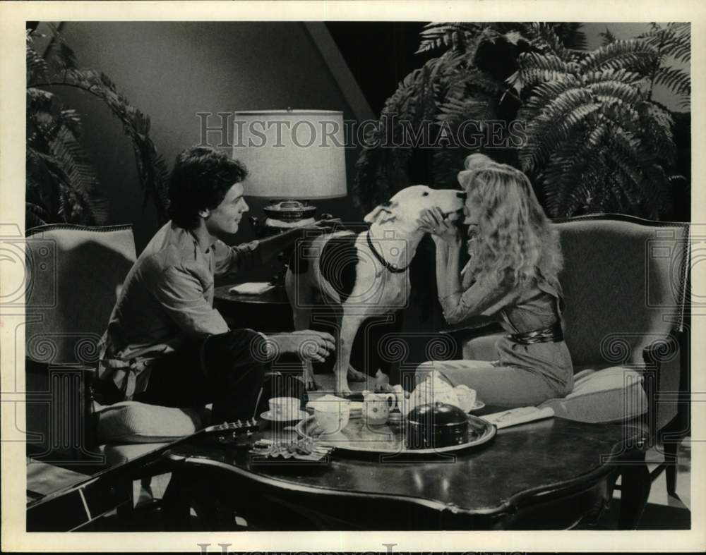 Press Photo Man Watches Dog Lick Woman's Face in Living Room - Historic Images