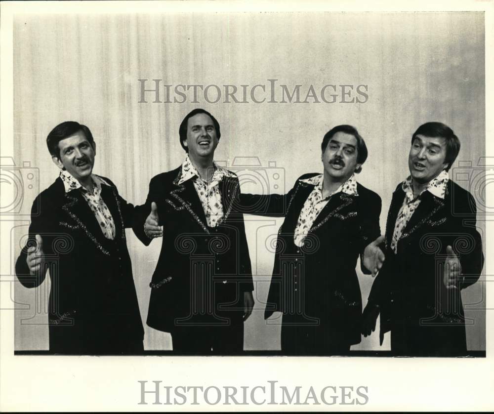 A singing group performing on stage. - Historic Images