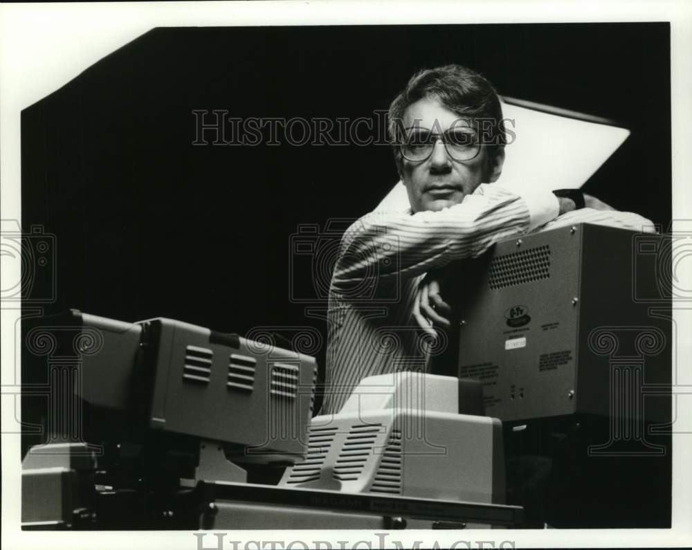 Press Photo Man Leans on Film Projector - Historic Images