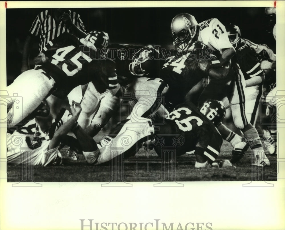 Press Photo Lee and Roosevelt High School Football Players at Game Tackle - Historic Images