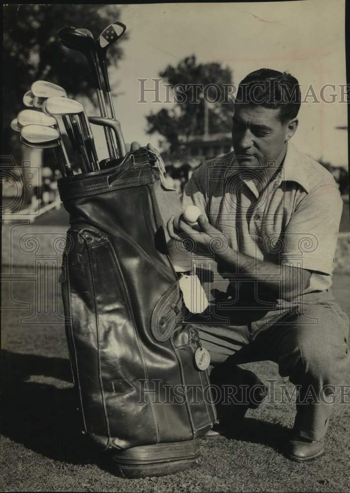 Golfer Jim Turner Kneels on Course, Pulls Balls From Bag - Historic Images