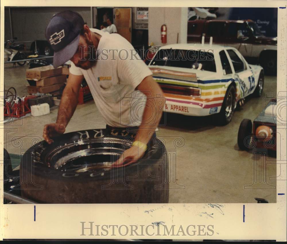 1988 Press Photo Grand Prix Pit Crew Member Mark Willis Cleans Tires in Garage- Historic Images