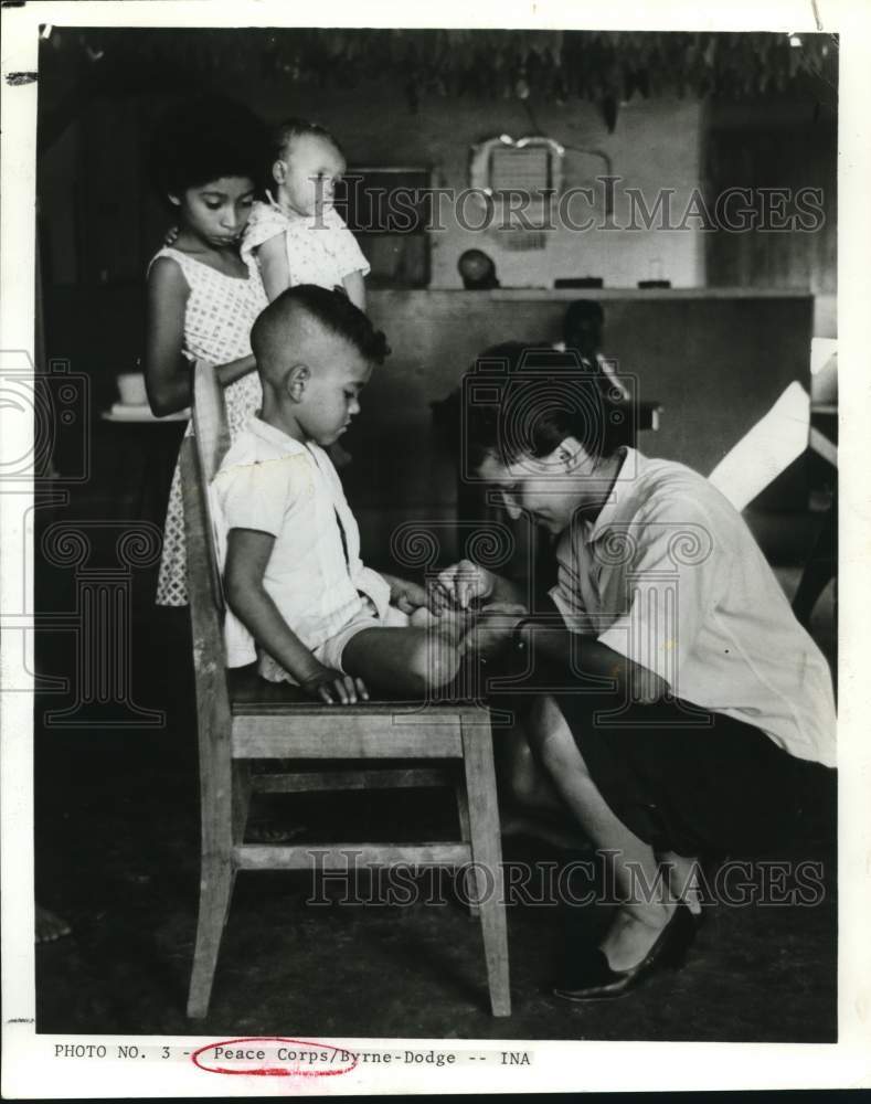 Press Photo eace Corps volunteer takes care of a youngster in Rio de Janiero- Historic Images