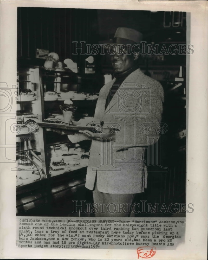 1954 Press Photo Boxer Tommy Hurricane Jackson eats at New York Restaurant- Historic Images