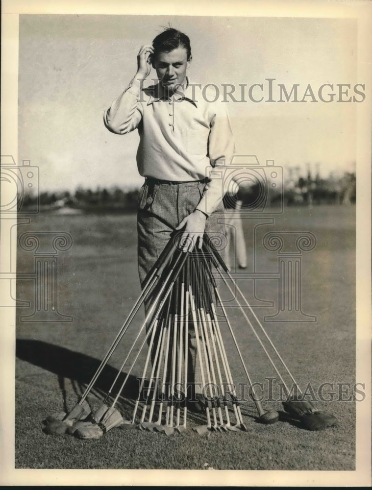 1937 Charles Whitehead holds all of his golf clubs in Miami FL - Historic Images