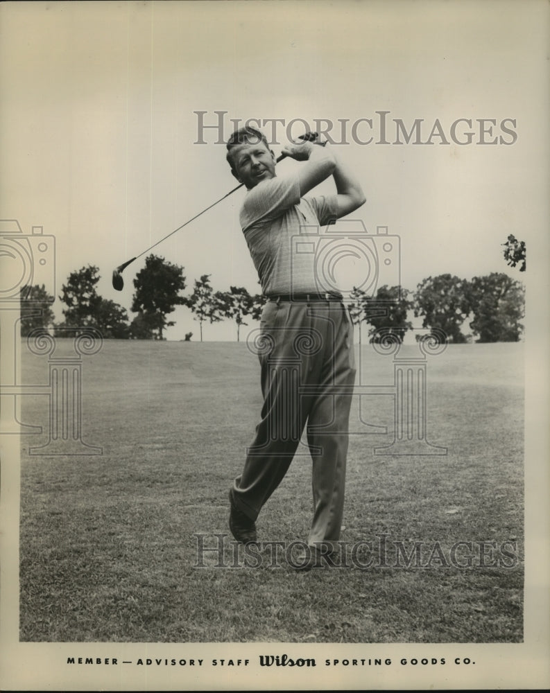 Pete Cooper shown in a golf action - Historic Images
