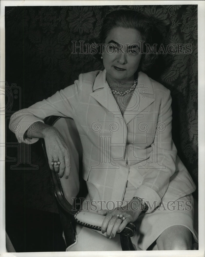 A portrait of a woman sitting on a bench - Historic Images