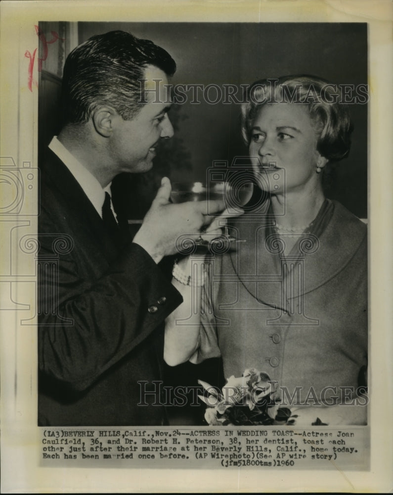 1960 Joan Caufield and Robert Peterson toast after their marriage - Historic Images