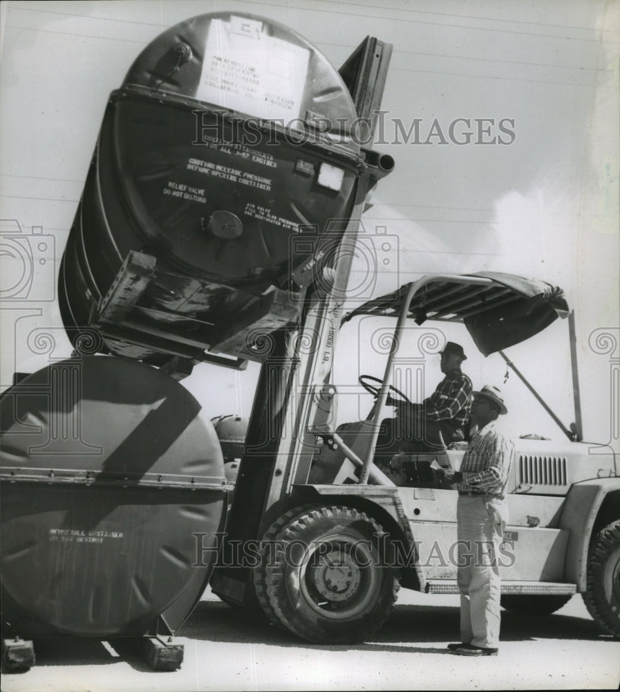 Press Photo Ulysses Chack and Horace Soliman work with the engine storage-Historic Images