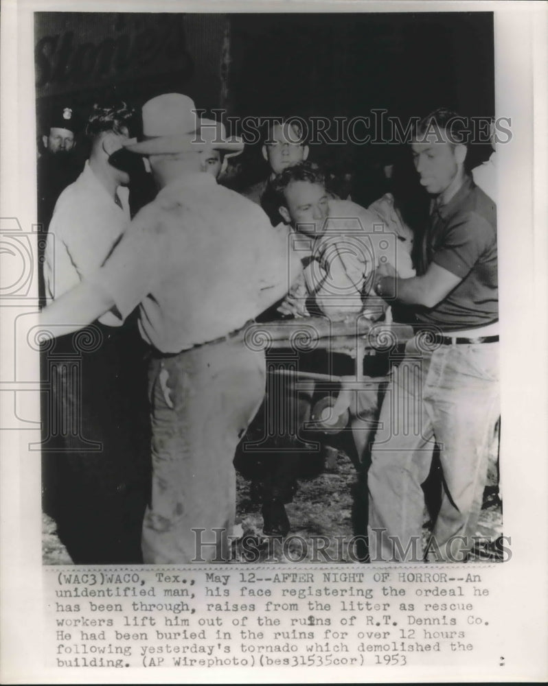 1953 Rescuers lift a survivor out of wrecked R.T. Dennis building - Historic Images