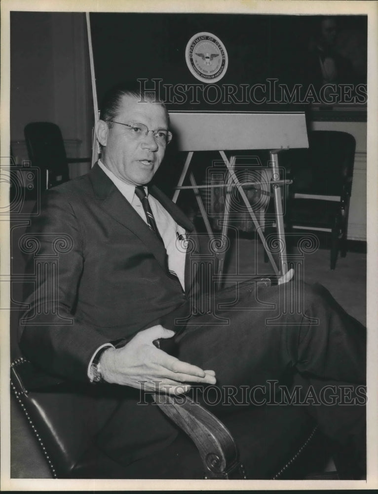 Press Photo A man sits in an office chair during an interview - Historic Images