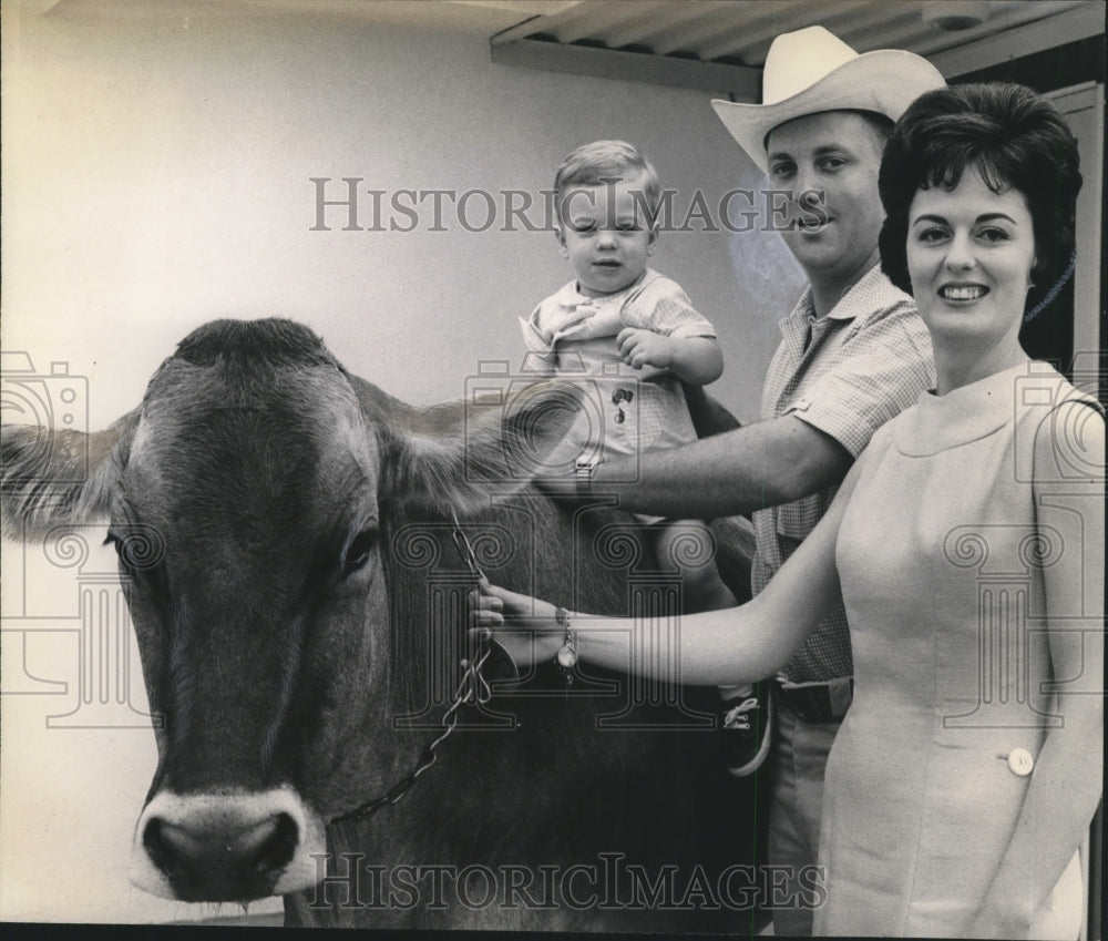 Jim Knowlton with a woman, child and a steer - Historic Images