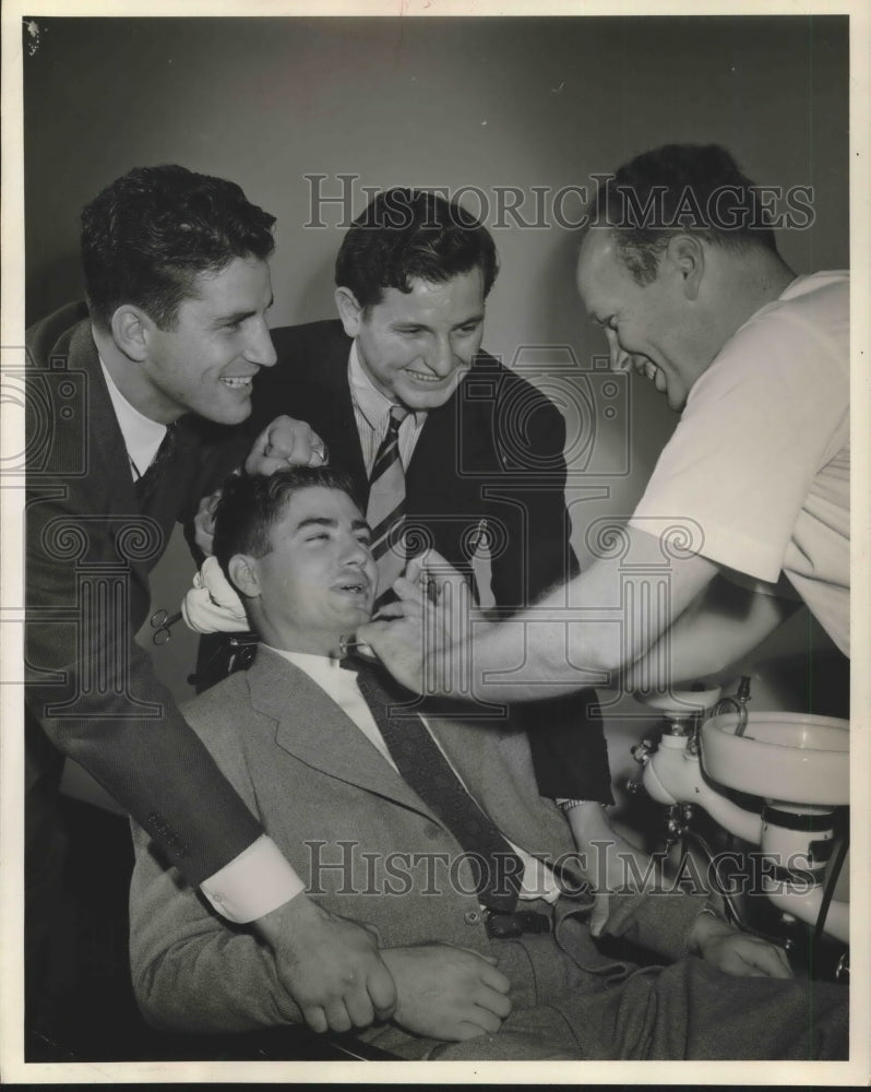 Press Photo Mr Daniel in dentist&#39;s chair surrounded by other men - Historic Images
