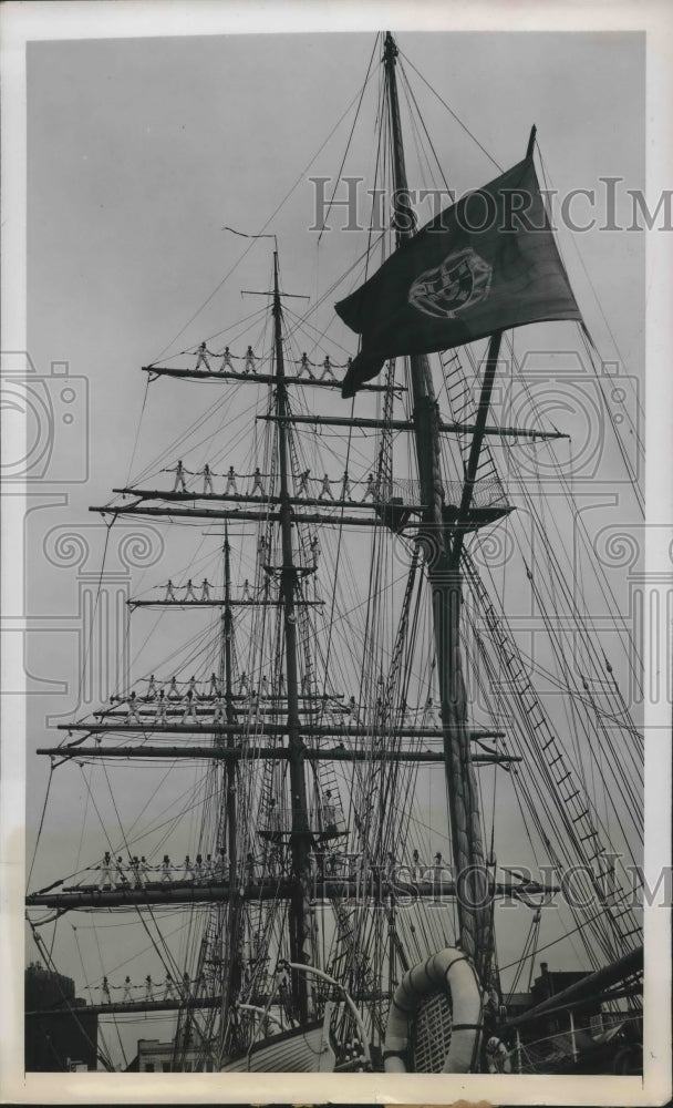 Rigging on masts of an old sailing ship with men standing on masts-Historic Images