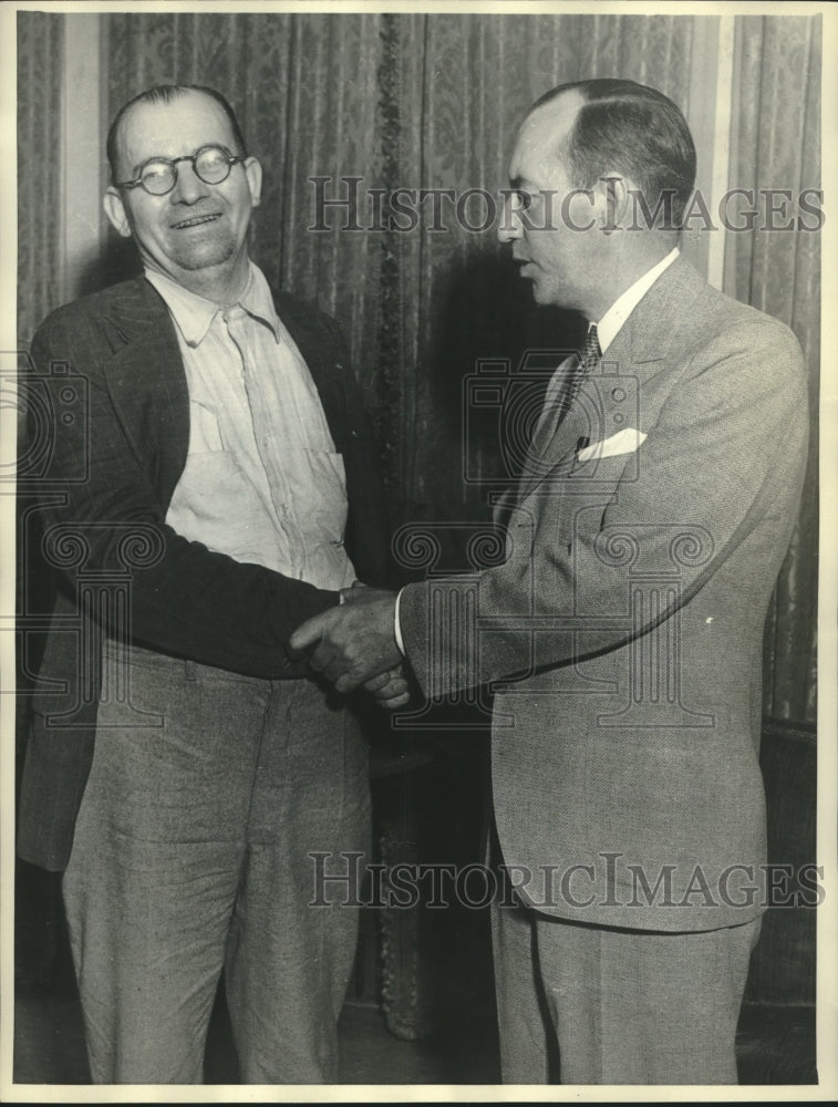 1934 William Gettle welcomed by Attorney E. E. Noon after his rescue - Historic Images