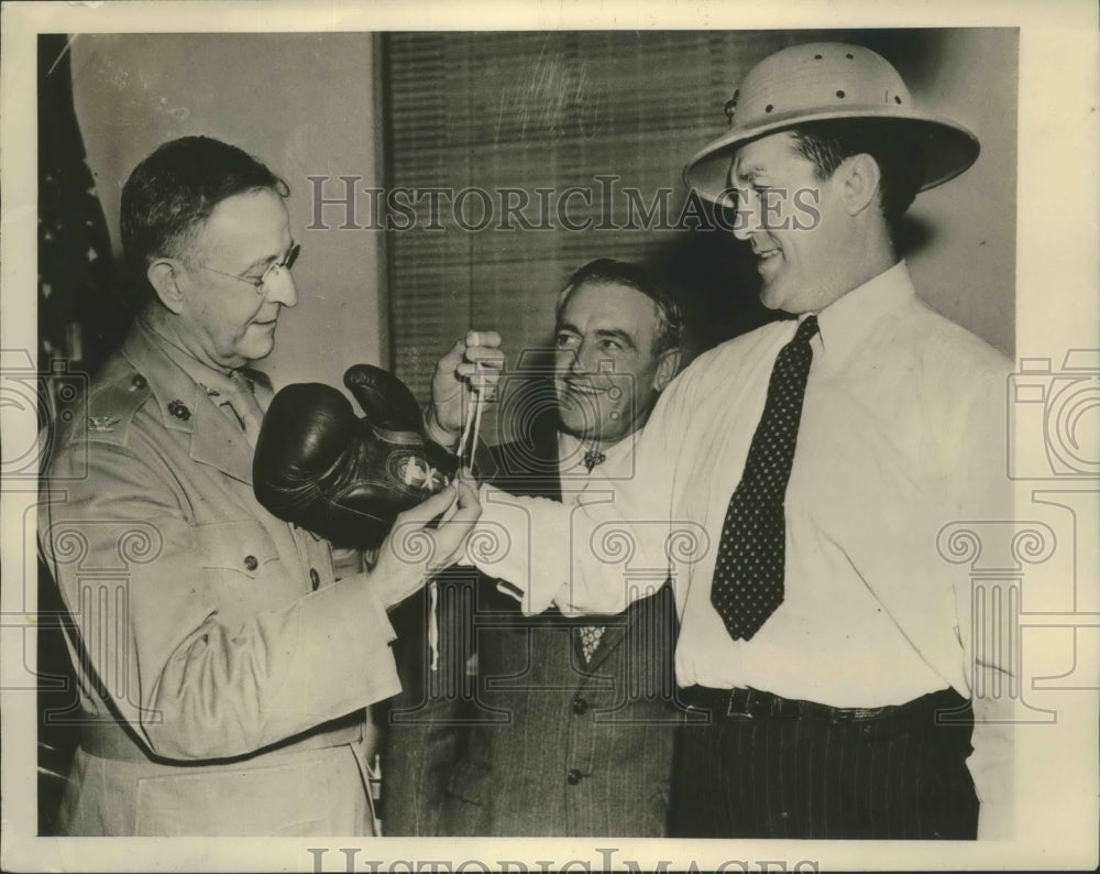 1942 Press Photo Tommy Loughran tries on his old boxing gloves - sbs01799 - Historic Images