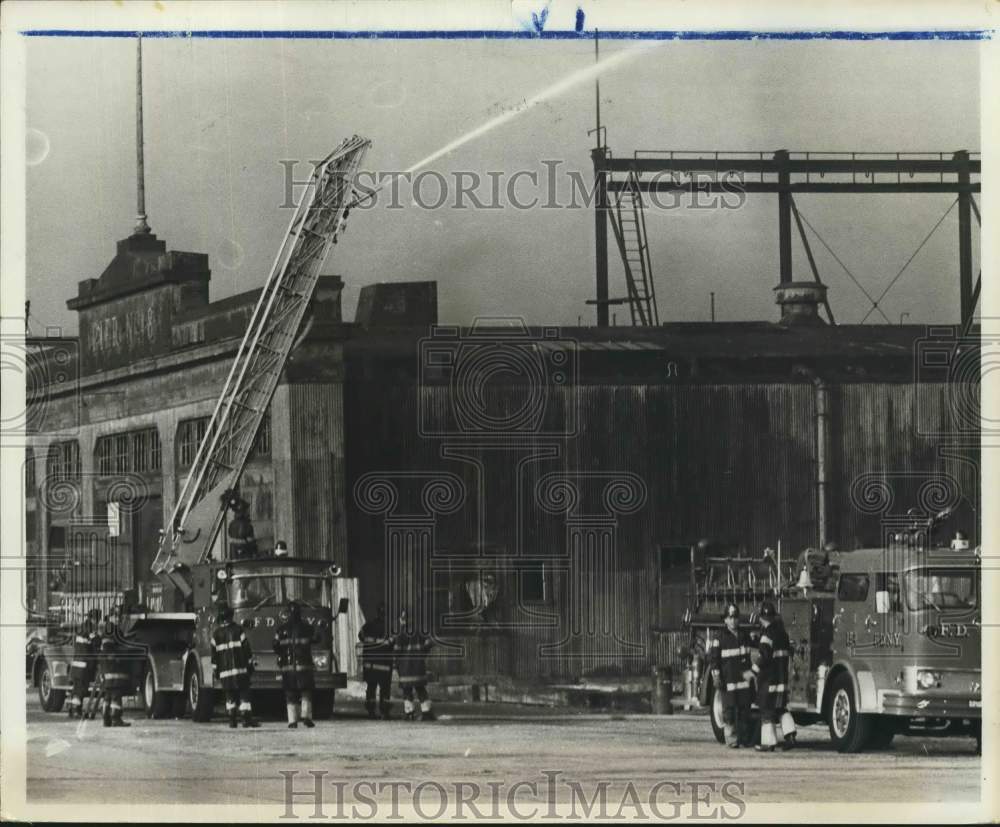 1987 Firefighters battle a blaze with a ladder engine - Historic Images