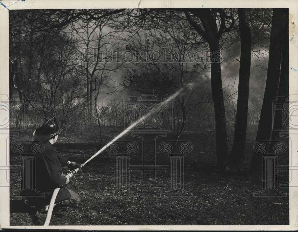 1957 A Firefighter fighting the Sea View brush fire-Historic Images