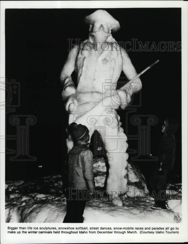 Press Photo Child admiring an ice sculpture, Idaho - Historic Images