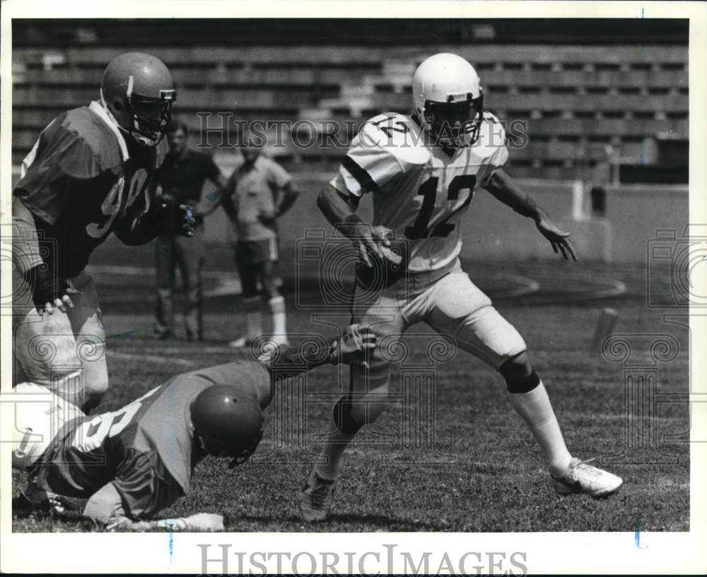Press Photo Wagner football ball carrier evades a grab during team scrimmage - Historic Images