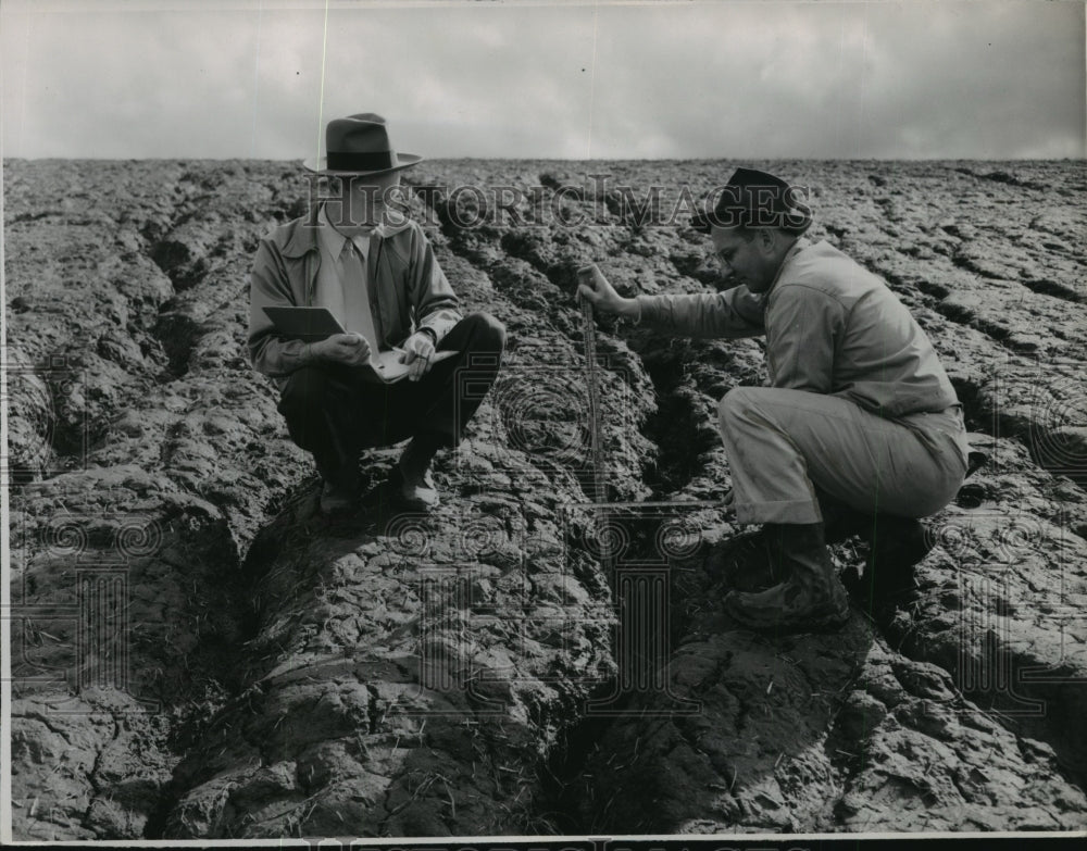 Press Photo Men studying soil erosion - spa56872 - Historic Images