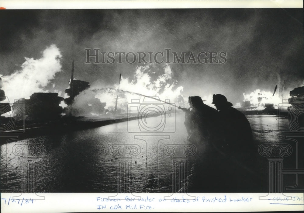 1984 Firemen pour water on lumber stacks in Coeur d'Alene Mill Fire-Historic Images