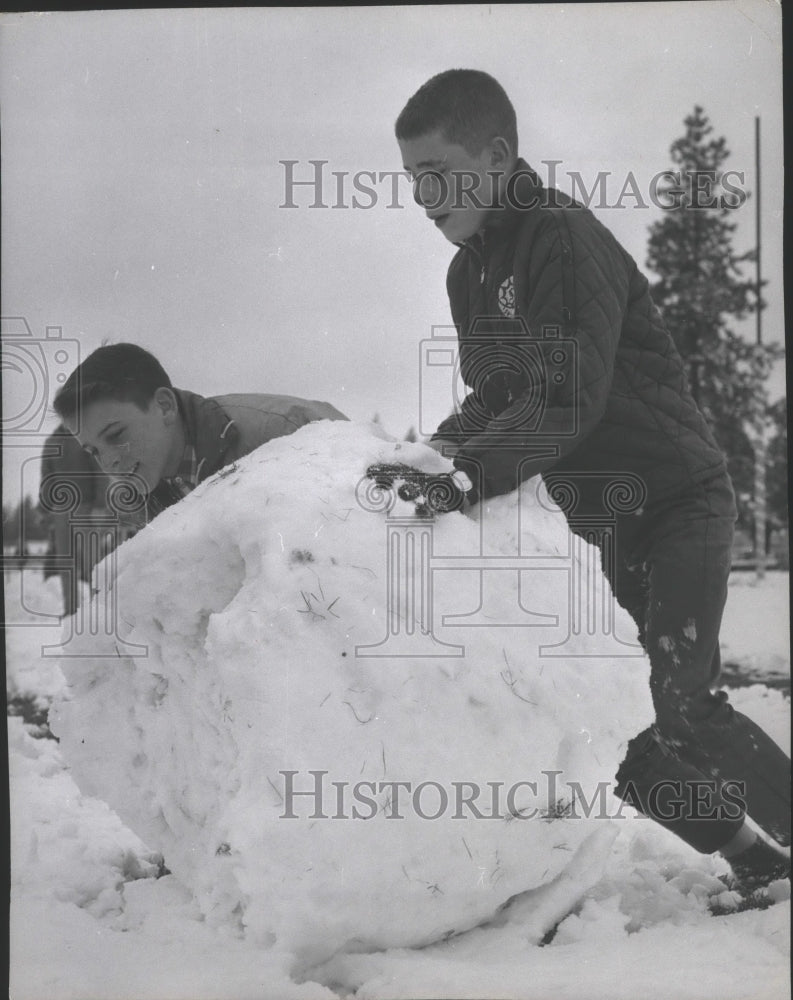 1964 Press Photo Children-Winter play scenes-Two young boys make huge snowball - Historic Images