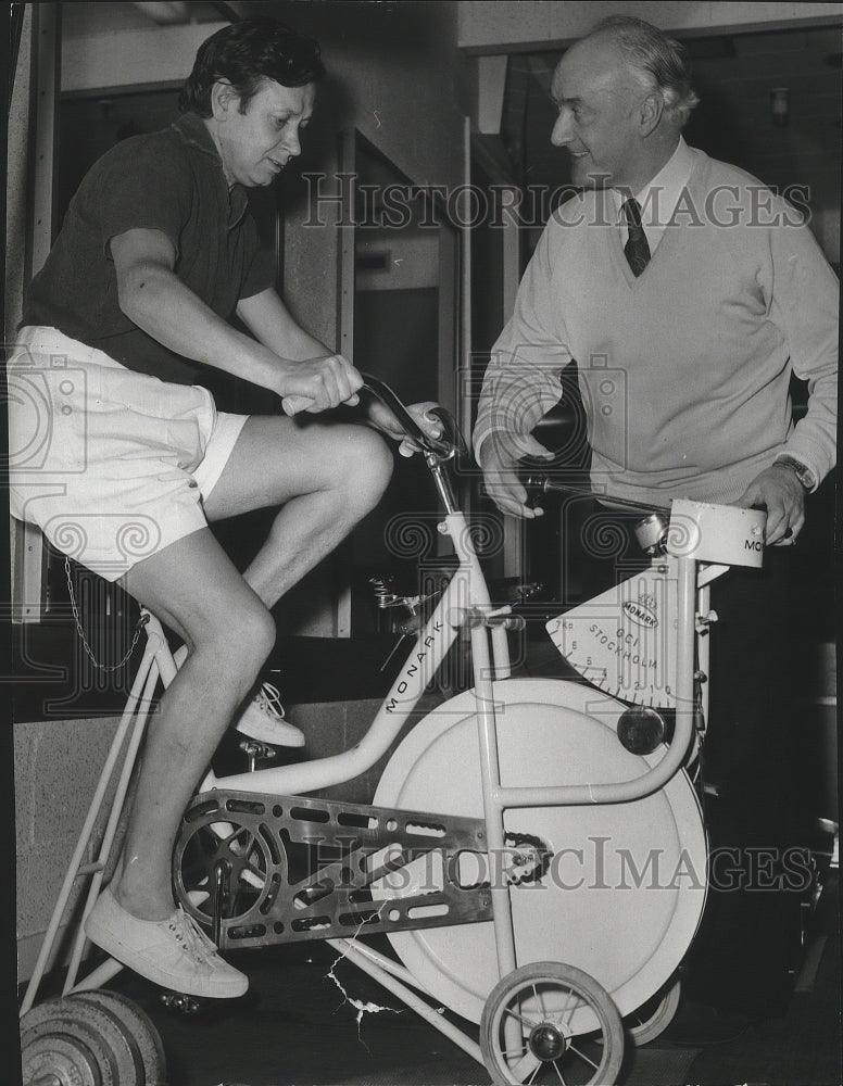 1977 Press Photo Hugh A. Mulligan does physical fitness on a bike - spa84881 - Historic Images