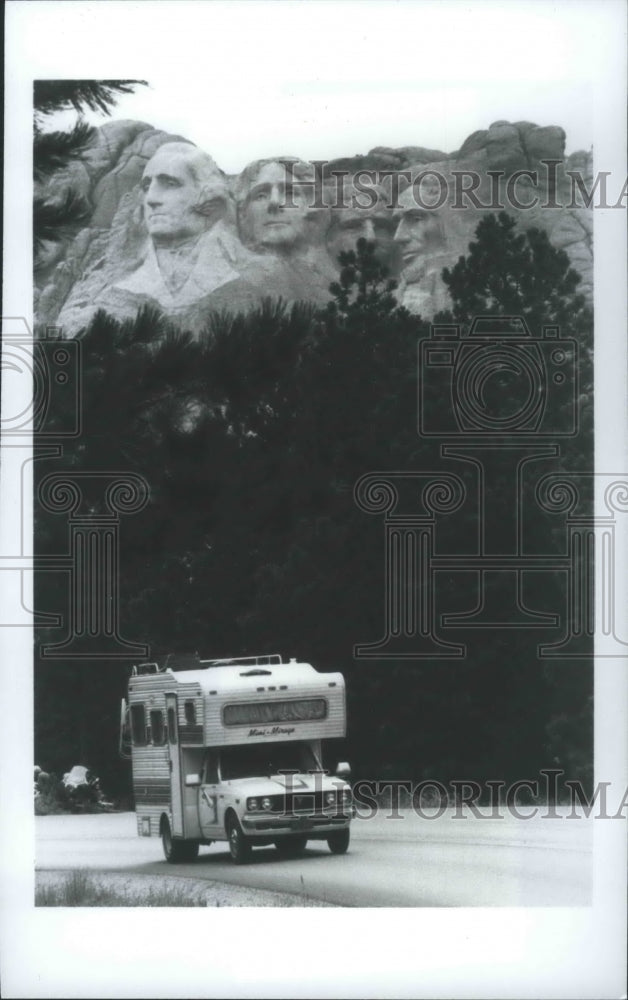 1986 Camper driving on road below Mount Rushmore-Historic Images