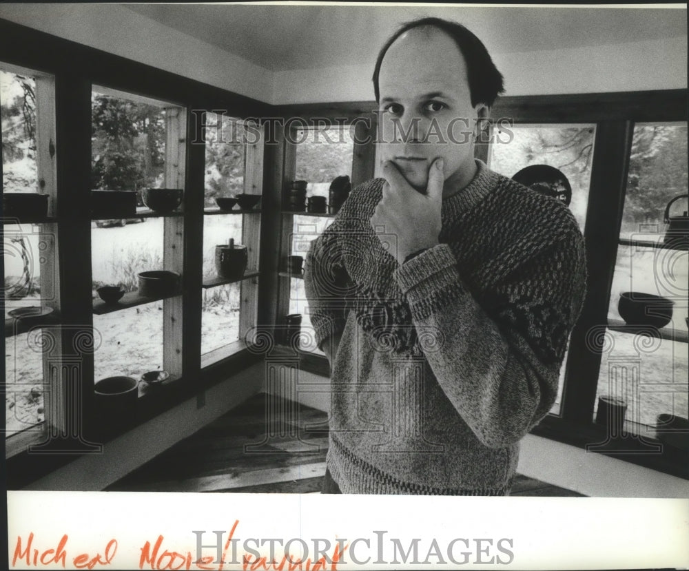 1983 Press Photo Michael Moore, ceramics artist, with pottery displayed - Historic Images