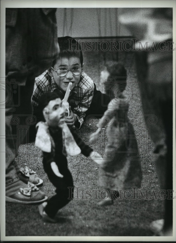 1992 Robby Brown watches  puppet show,  Medical Lake Library, Idaho-Historic Images