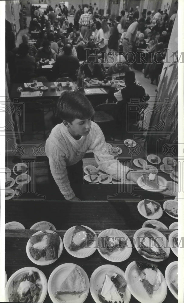 1992 Damlen Day serving pie at Thanksgiving dinner at St Patrick's-Historic Images