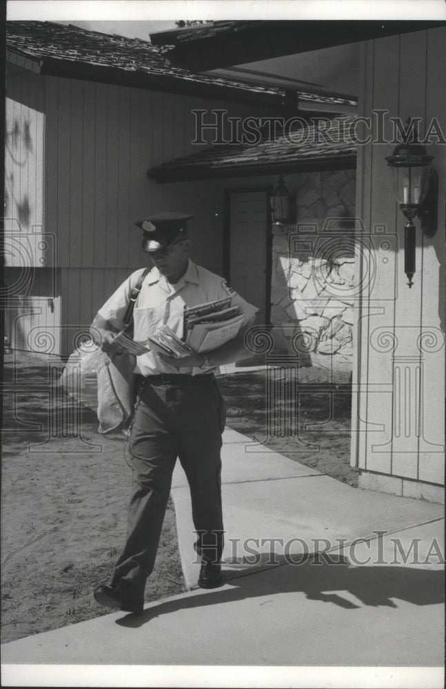 1975 Postal worker walks on delivery route, Spokane Post Office