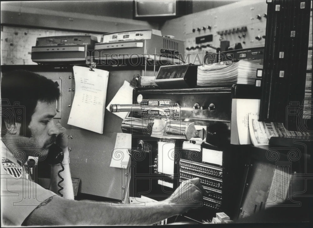 1977 Worker answers telephone at Spokane alarm center-Historic Images