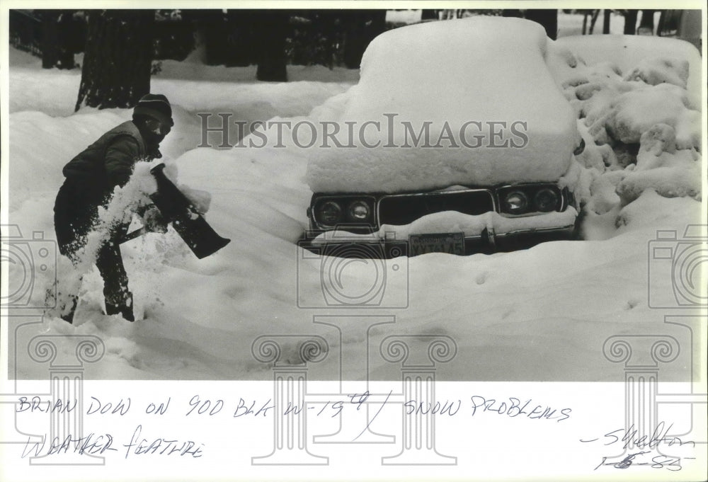 1986 Press Photo Brian Dow shovels snow off the sidewalk on the 900 Block W-19th - Historic Images