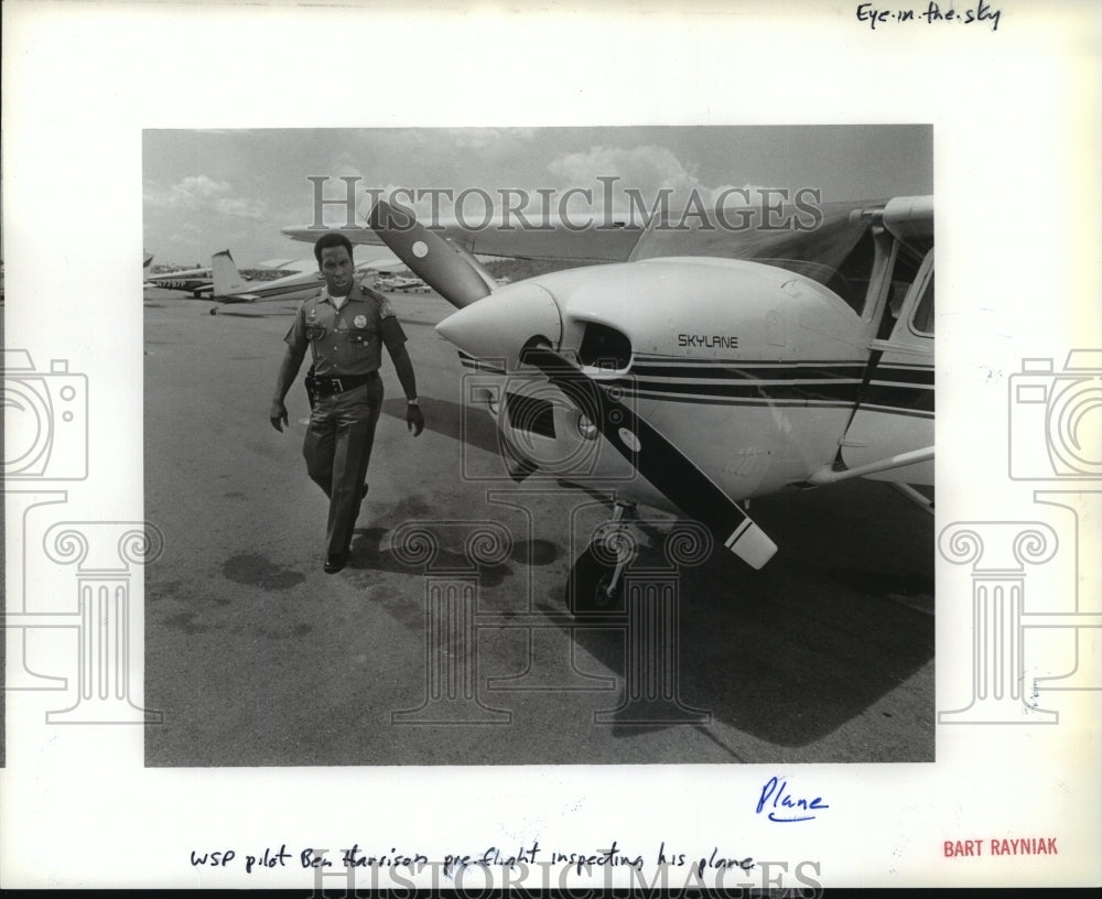 1989 State Trooper Ben Hamilton inspects his Plane in Washington