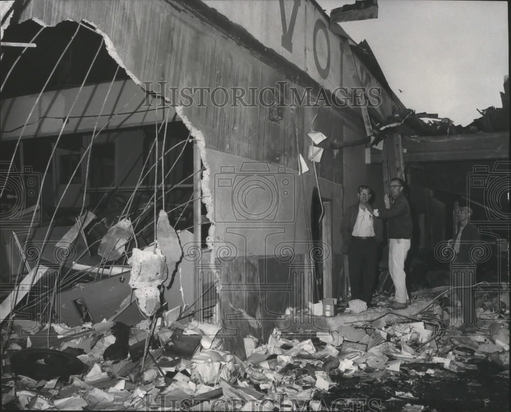 1966 Group of men examine the destruction after blast - Historic Images