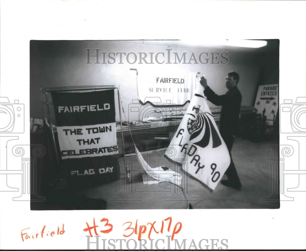 1990 Press PhotoRick Loettler sorts banners that will hang in Fairfield Flag Day - Historic Images