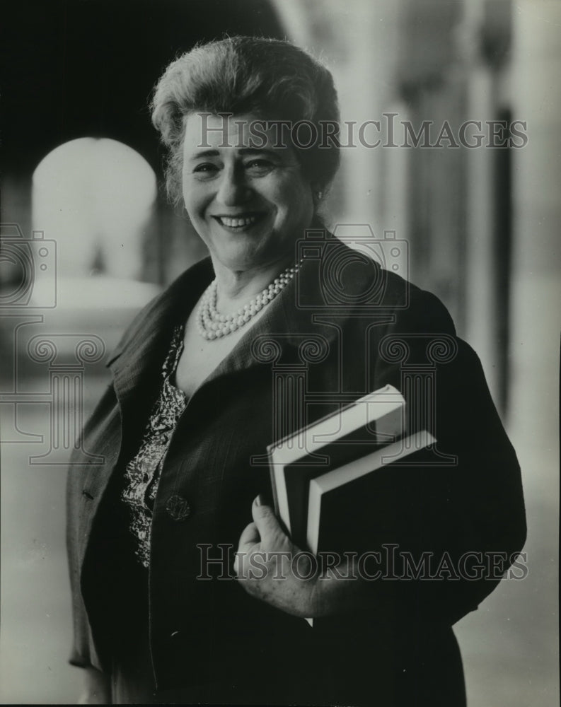 1961 Press Photo Lady holds several books while smiling - Historic Images