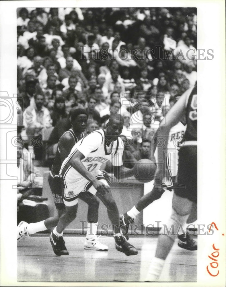 1991 Basketball star Stacey Augmon is careful with the ball - Historic Images